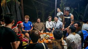a group of people sitting around a table at Mama Pham Homestay in Tả Van