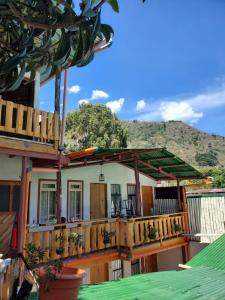 a house with a deck with a mountain in the background at Luminous Haven Atitlan #1 in San Marcos La Laguna