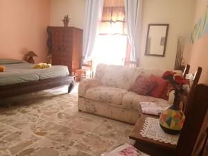 a living room with a couch and a bed at Bed and Breakfast Baobab in Piazza Armerina
