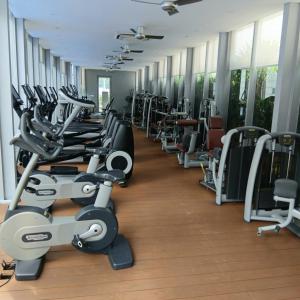 a gym with rows of exercise bikes and treadmills at Vortex suites klcc by kl cozy home in Kuala Lumpur