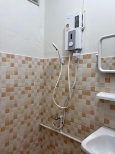 a shower in a bathroom with a sink at Mama's Tree Homey Studio in Ban Klaeng Lang