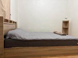 a bed in a white room with at Mama's Tree Homey Studio in Ban Klaeng Lang