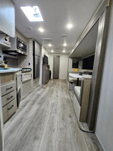 a large kitchen with wooden flooring in a trailer at Pilot Glamp in Vieques +11 photos