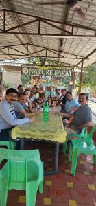 a group of people sitting at a table at YR'S Nature Farmhouse in Badlapur