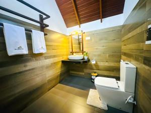 a bathroom with a toilet and a sink at Oak Haven Cabana Sigiriya in Sigiriya