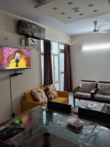a living room with a couch and a glass table at Friendly Service Apartment in Ghaziabad