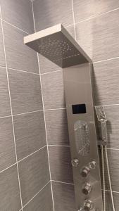 a shower with a shower head in a bathroom at The Sandpearl in Stevensville +60 photos
