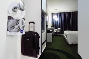 a hotel room with a picture of a baby on the door at Idea Hotel Milano Malpensa Airport in Case Nuove