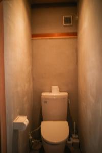 a bathroom with a white toilet in a room at 0site house in Hokuto