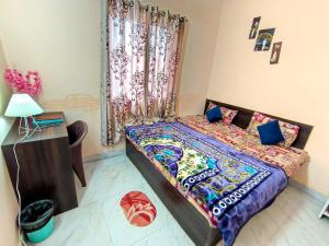 a bedroom with a large bed with blue pillows at Shivashrays Homestay in Rānchī