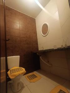 a small bathroom with a toilet and a sink at Eds pousada II in Juazeiro do Norte
