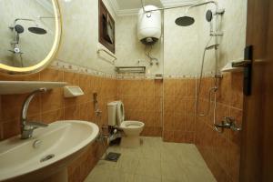 a bathroom with a sink and a toilet and a mirror at ABo ZAIN HOSTEL in Aswan
