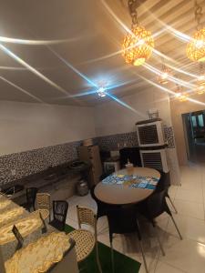 a room with a table and chairs and lights at Eds pousada II in Juazeiro do Norte