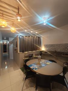 a dining room with a table and chairs and lights at Eds pousada II in Juazeiro do Norte