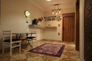 a dining room with a table and chairs and a door at ABo ZAIN HOSTEL in Aswan