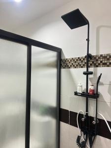 a shower with a glass door in a bathroom at Eusel's Place Butuan in Butuan +25 photos