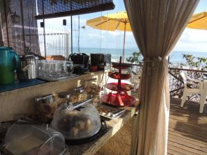 a buffet with food on a table on a balcony at Pousada Ancoradouro's in Florianópolis
