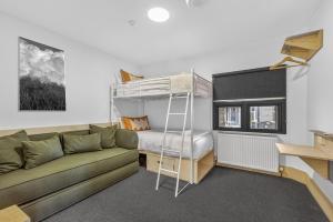 a living room with a couch and a bunk bed at Nelse Lodge in Falls Creek