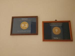 two picture frames on a wall with numbers on them at Bed and Breakfast Baobab in Piazza Armerina