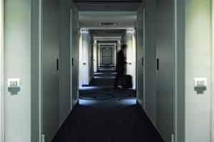 a man walking down a hallway in a building at Idea Hotel Milano Malpensa Airport in Case Nuove