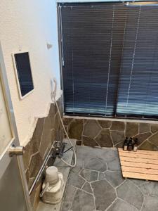 a bathroom with a stone shower with a window at Yama Chalet in Rankoshi +20 photos