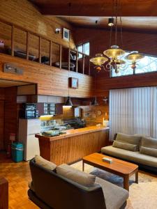 a living room with a couch and a table at Yama Chalet in Rankoshi