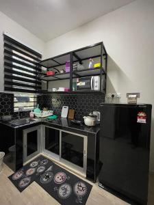 a kitchen with a black counter top with a sink at The 736 Homy in Melur