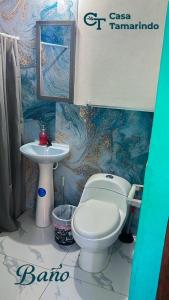 a bathroom with a toilet and a sink at Casa Tamarindo in Las Peñitas +11 photos
