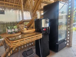 a kitchen with a black refrigerator and a counter at Mangoverde Guesthouse in Moalboal
