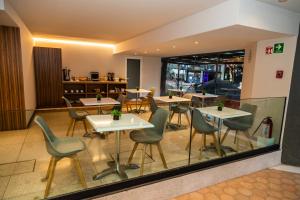 a restaurant with tables and chairs in a room at Hotel Casa Ciudad in Mexico City
