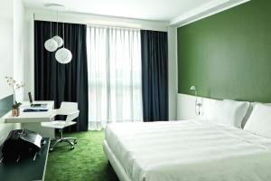 a bedroom with a bed and a desk with a computer at Idea Hotel Milano Malpensa Airport in Case Nuove