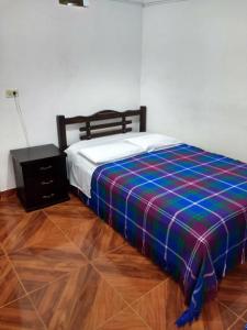 En eller flere senge i et værelse på Hotel El Turista