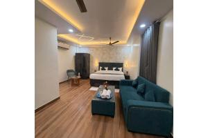 a living room with a bed and a couch at Hotel Raas Grand in Sachendi +37 photos