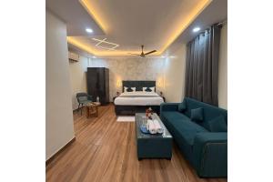 a living room with a bed and a couch at Hotel Raas Grand in Sachendi