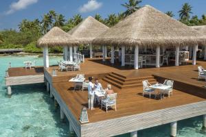 a restaurant on a dock in the water at Ayada Maldives - Complimentary domestic transfer for 2 Adults for stays of 7 nights or more, valid for stay dates from May through the end of September 2026 in Vaadhoo