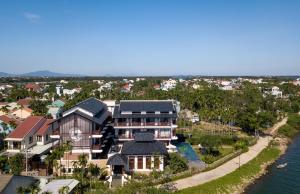 an aerial view of a house next to the water at Nghê Prana Hotel & Spa Hoi An in Hoi An