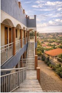a building with a staircase leading up to a balcony at NOAZ Hotel Kampala in Kampala