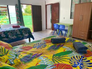 a bedroom with a large bed with two pillows on it at Punahere lodge Ohotu in Rangiroa