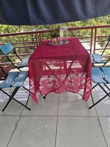 a pink table and two chairs on a balcony at Tam hien ho in Tân Hiệp