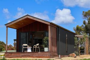 a tiny house with a black exterior at 3 Acres by the Moyne in Port Fairy
