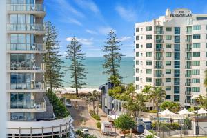 a view of two tall buildings next to the ocean at Direct Collective - Sea Breeze Mooloolaba in Mooloolaba