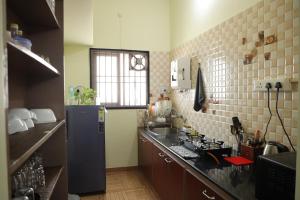 a kitchen with a blue refrigerator and a sink at Villa LOR in Pondicherry +9 photos