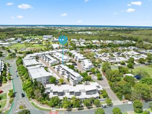 an aerial view of an apartment complex with a parking lot at Direct Collective - Breeze on Brightwater in Mooloolaba