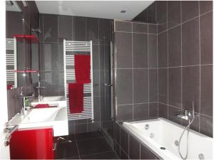 a bathroom with a bath tub and a sink at Maison de Manne in Saint-Just-de-Claix