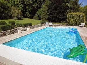 a swimming pool with a fish in the middle of it at Maison de Manne in Saint-Just-de-Claix