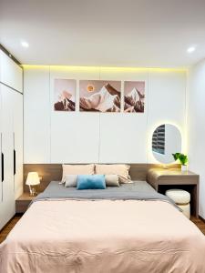 a bedroom with a large bed and a desk at AnChi Homestay in Hòa Bình