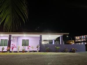 a white building with flowers on it at night at Rumah Impian Bapa in Semporna