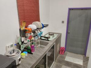 a kitchen with a sink and a counter top at Rumah Impian Bapa in Semporna +15 photos