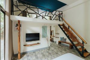 a living room with a tv and a staircase at Toptai Kenting BY REINDEER in Kenting