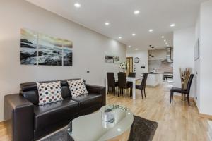 a living room with a couch and a table at San Pietro Vatican Apartments in Rome